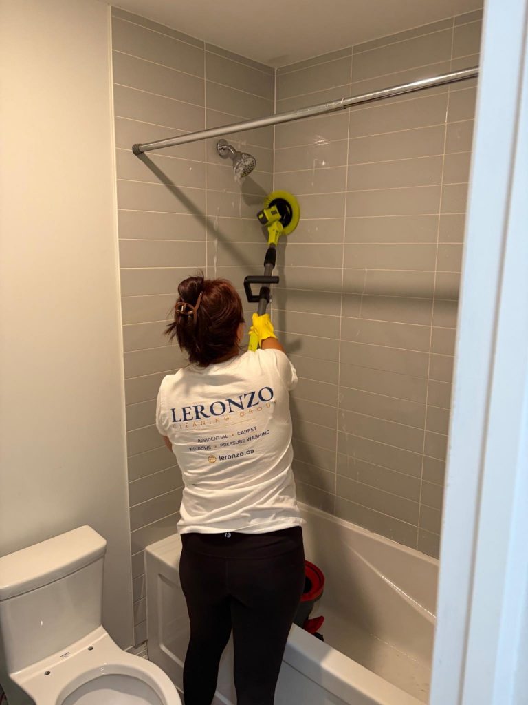 Three professional cleaners working together in a bright residential dining room