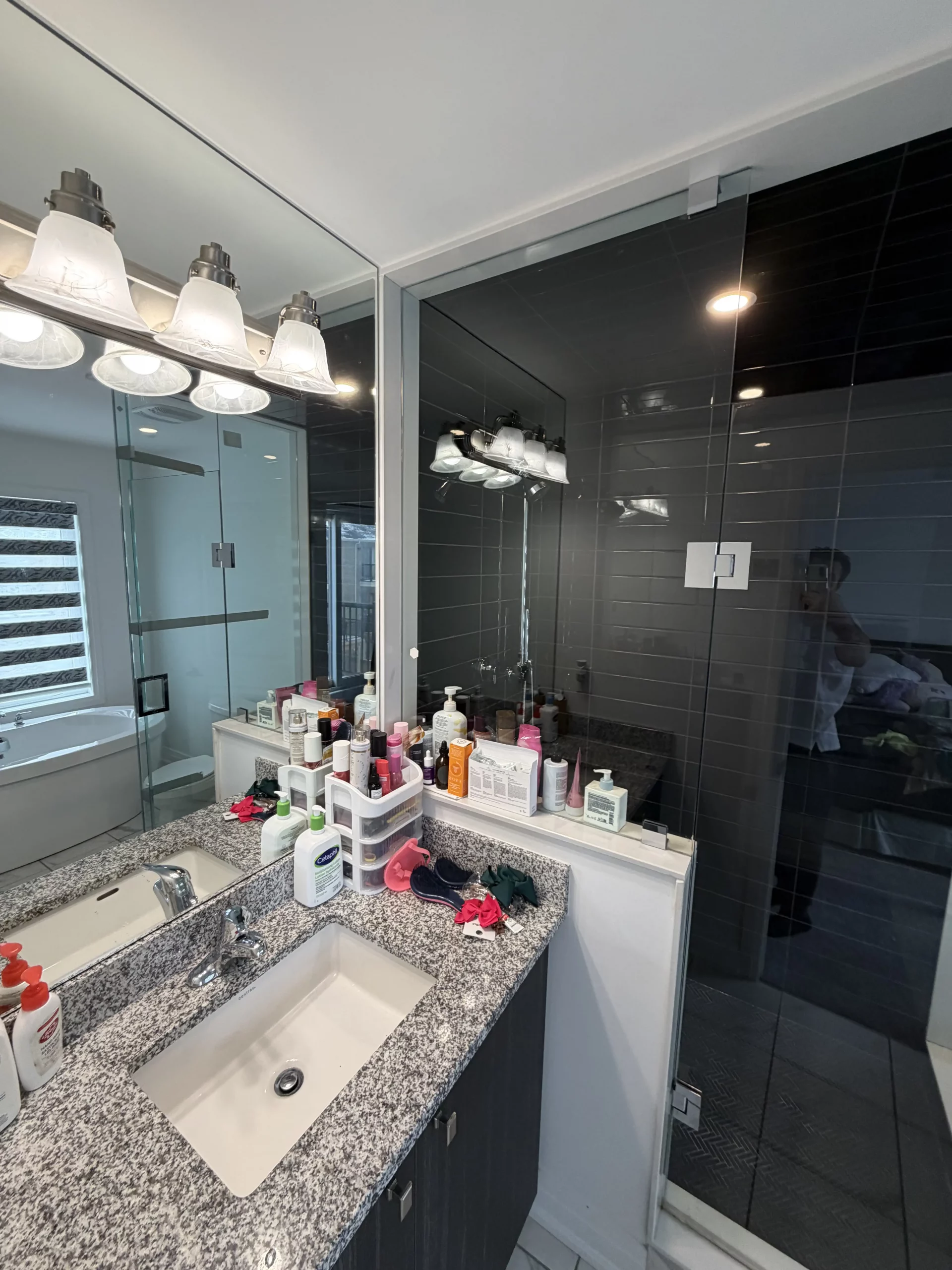 Bathroom vanity with personal items that should be cleared before deep cleaning